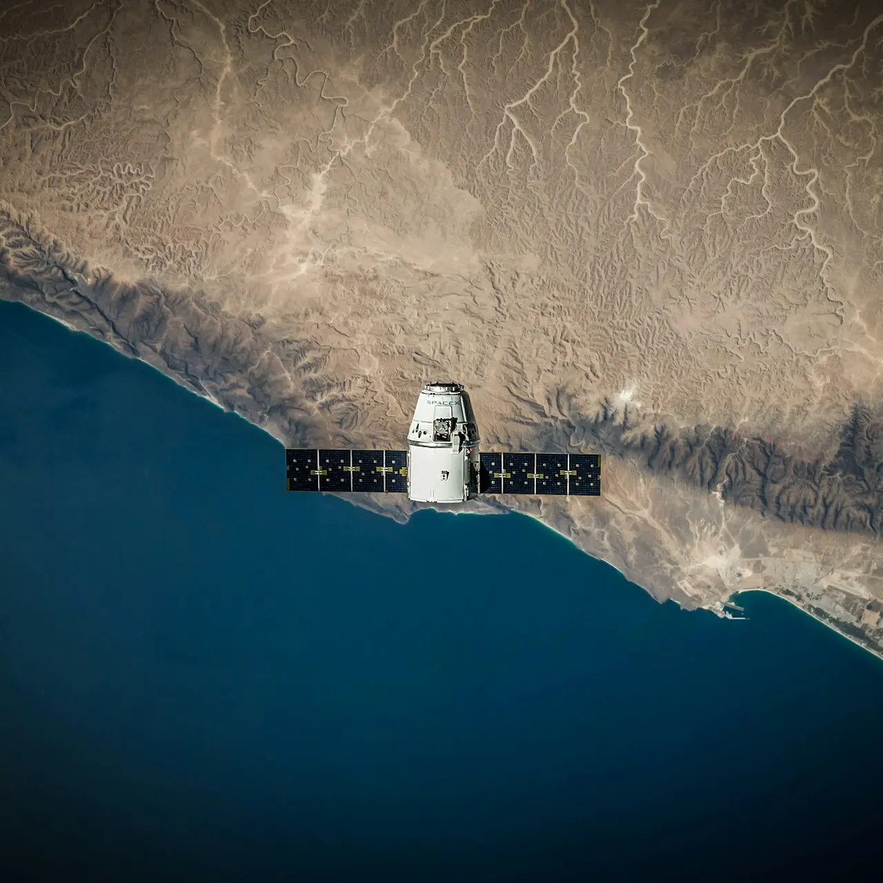 A space satellite hovering above the coastline