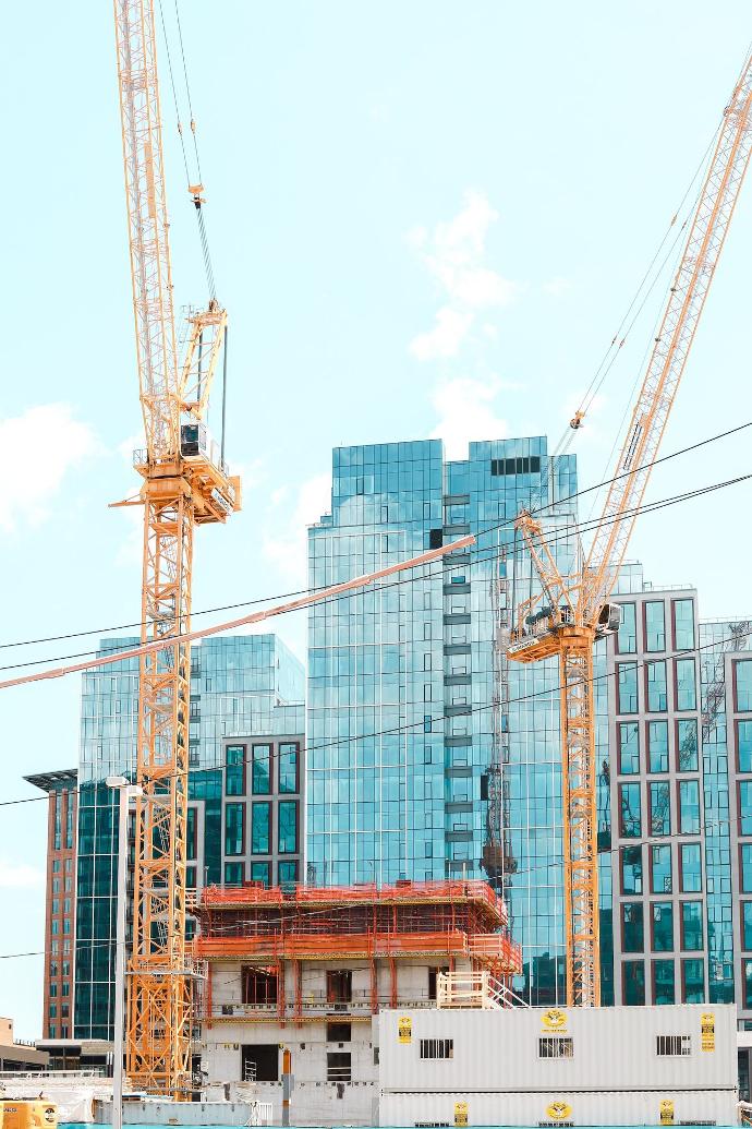 yellow crane near building during daytime